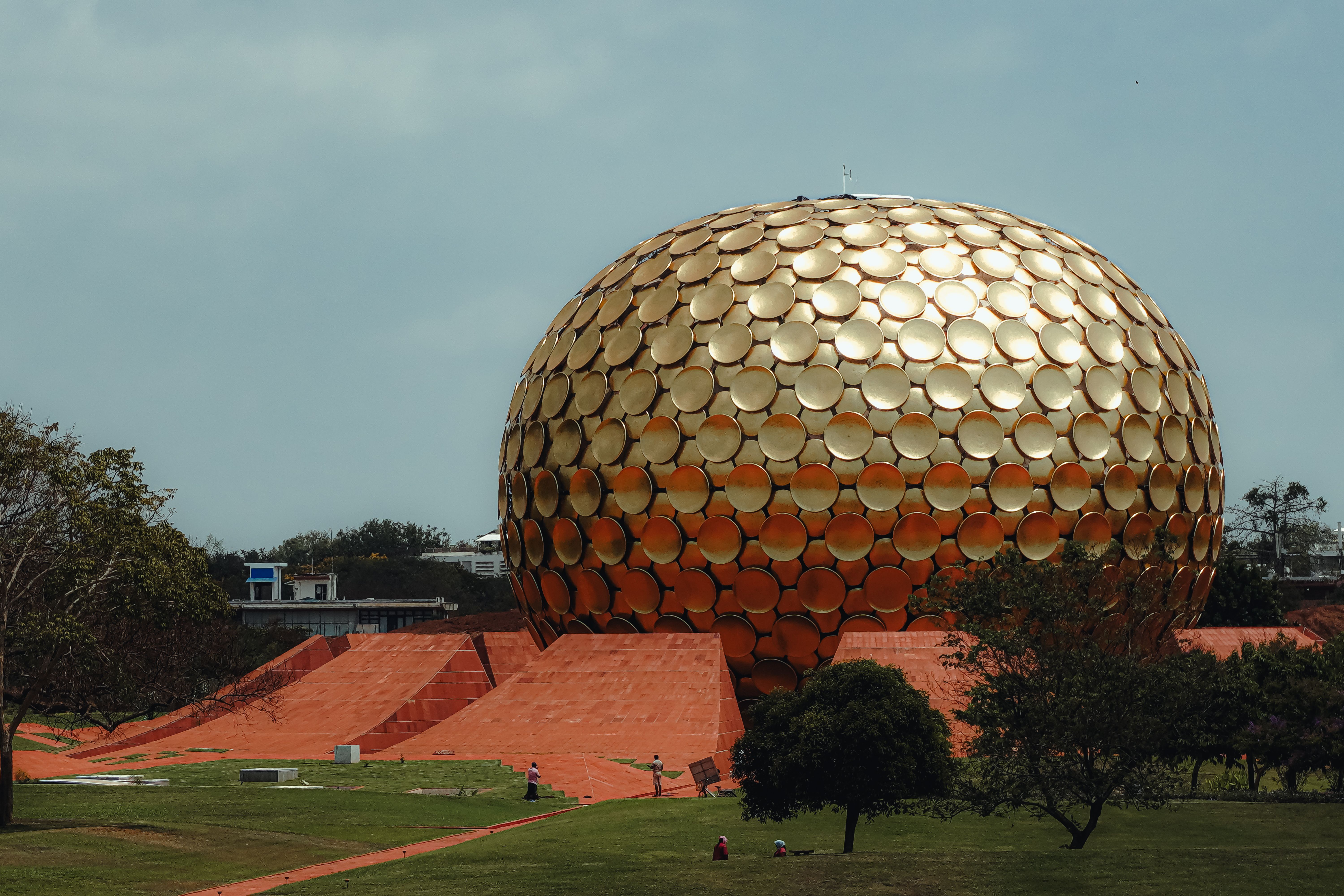 Community gathering in Auroville with cyclists